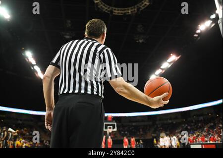 Basketball Referee Holding a Ball in a Sports Arena Before Putting the Ball Back into Play Stock Photo