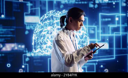 Hardworking system administrator in data center uses artificial intelligence computing simulating human brain thought processes. Server room manager works on tablet with AI machine learning algorithms Stock Photo