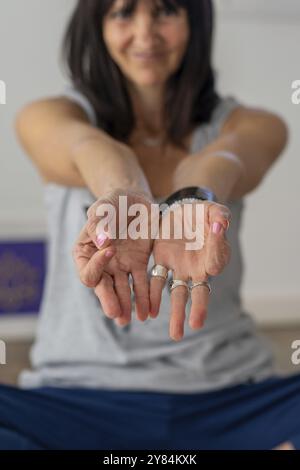 Close-up of a yoga and meditation coach's hands making Chin Mudra Stock Photo