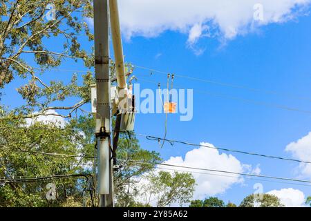 Several power lines have been damaged by severe violent hurricane, which is being repaired by emergency workers Stock Photo