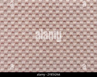 Close up of pink peach fabric in checkerboard or checkered pattern, square and rectangular pattern. Seamless pink fabric background texture. Stock Photo