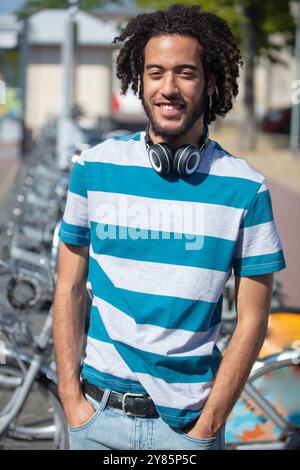handsome young man in casuals walking down the street Stock Photo