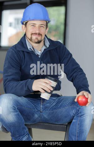 male construction worker eating apple Stock Photo