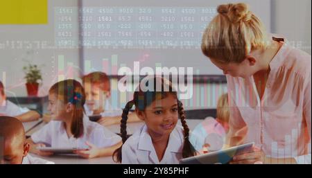 Children using tablets in classroom with data processing image over them Stock Photo