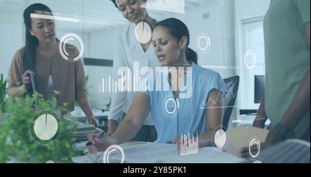 Business data analytics image over diverse team collaborating in modern office Stock Photo