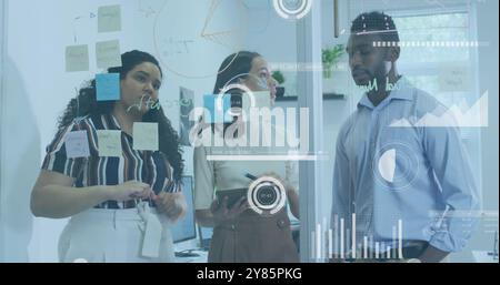 Business analytics and data visualization image over diverse team discussing in office Stock Photo