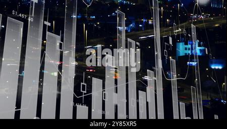 Financial data charts and graphs image over cityscape at night Stock Photo