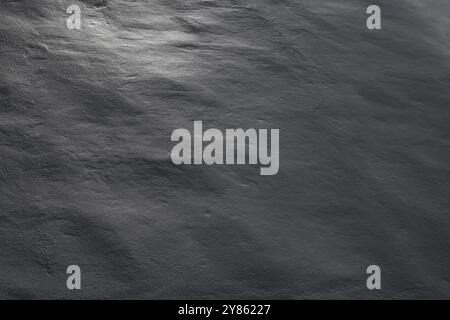 Close-up of a clean, uneven and plastered wall in black and white. Beautiful sidelight creates soft shadows. Abstract textured background, copy space. Stock Photo