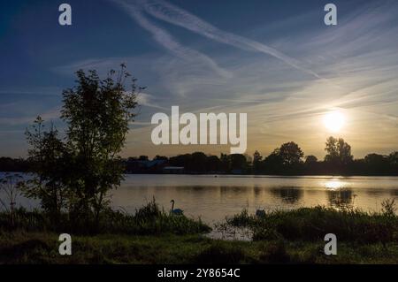 Early morning sunrise over Gunwade Lake Ferry Meadows Ham Lane Peterborough Cambridgeshire UK Stock Photo