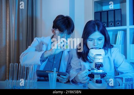 Scientists Conducting Experiments in a Modern Laboratory Setting with Advanced Equipment and Technology Stock Photo