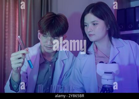 Scientists Conducting Experiments in a Modern Laboratory Setting with Advanced Equipment and Technology Stock Photo