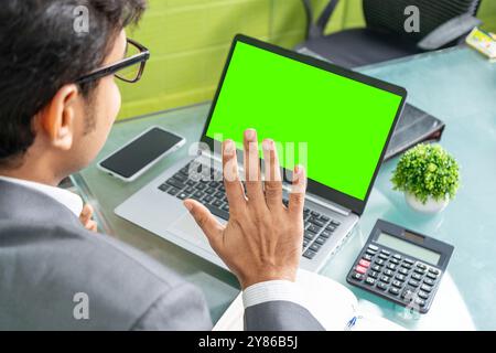 A cheerful businessman is seen in a modern office, engaged in a productive online conversation with a client overseas. His positive demeanor reflects Stock Photo