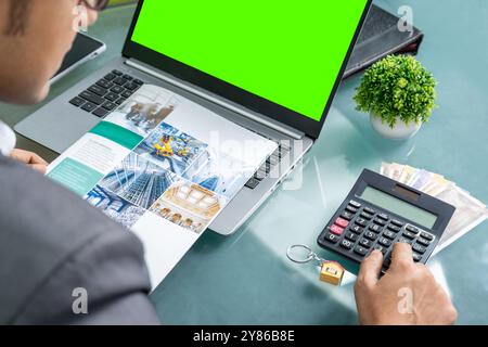 Securing a low-interest business loan: Entrepreneur in modern office focusing on strategic financial planning diligently working on securing a low-inte Stock Photo