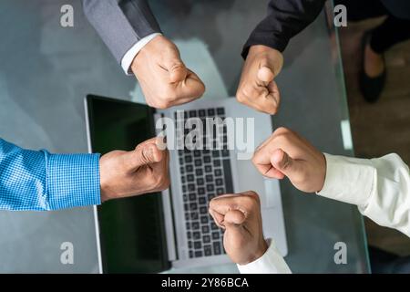 Diverse Team Unity - Hands Giving Thumbs-Up in Modern Office. A close-up of five diverse team members giving thumbs-up in a modern office setting, system Stock Photo