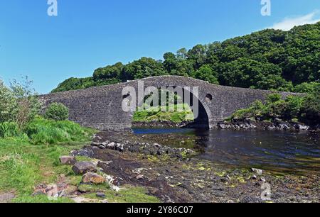 The Clachan Bridge (also known as the Bridge over the Atlantic) is a simple, single-arched, hump-backed, masonry bridge spanning the Clachan Sound, 13 Stock Photo