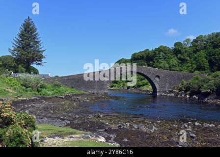 The Clachan Bridge (also known as the Bridge over the Atlantic) is a simple, single-arched, hump-backed, masonry bridge spanning the Clachan Sound, 13 Stock Photo