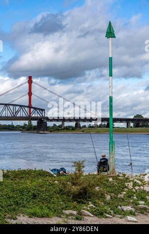 The Beeckerwerth Rhine bridge of the A42 highway, in front of it the Haus-Knipp railroad bridge, Angler on the Rhine near Duisburg, NRW, Germany Stock Photo