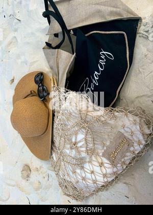 Beach bags with Boracay inscriptions, straw hat and sunglasses on the sand. High quality photo Stock Photo