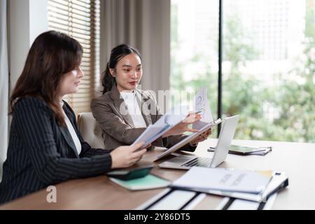 Business Team Analyzing Reports for Strategic Planning. Concept of Teamwork and Data-Driven Decision Making Stock Photo
