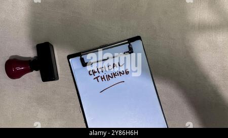 Concept of Critical Thinking write on paperwork isolated on wooden background. Stock Photo