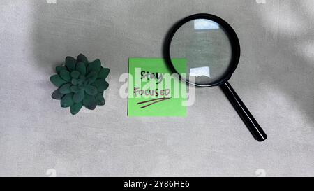 Concept of Stay Focused write on sticky notes isolated on Wooden Table. Stock Photo