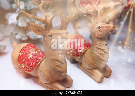 Two Christmas golden reindeer toy. Winter holiday decoration close up. Copy space. Christmas and new year celebration background. Holiday season conce Stock Photo