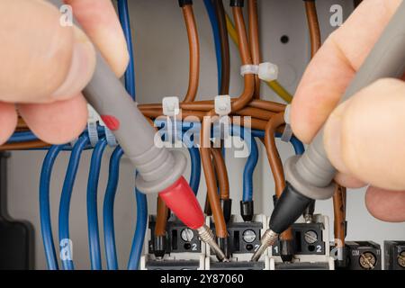 Testing electrical circuits with probes in a panel Stock Photo