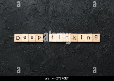 Deep Linking word written on wood block. Deep Linking text on cement table for your desing, concept. Stock Photo