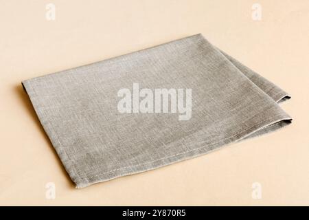 top view with gray kitchen napkin isolated on table background. Folded cloth for mockup with copy space, Flat lay. Minimal style. Stock Photo