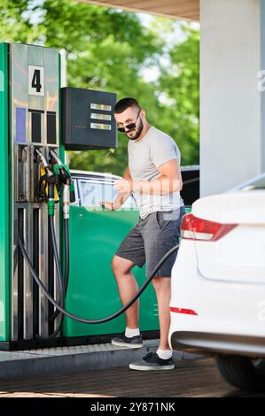 modern car at a gas station. white SUV pouring gasoline Stock Photo - Alamy