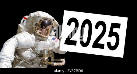 Astronaut in space holding a 2025 white  board - elements of this image are provided by NASA Stock Photo