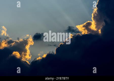 Natural scene sky clouds cumulus and sunrise sunrays background Stock Photo