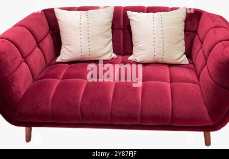 Red Sofa with two pillows. Red two-seat textile sofa with pillows, isolated on white. Mini double sofa, home furniture, house interior concept. Stock Photo