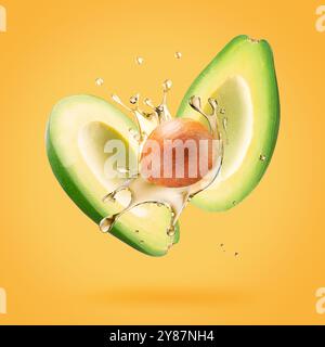 avocado with oil splash on a light green background. Stock Photo