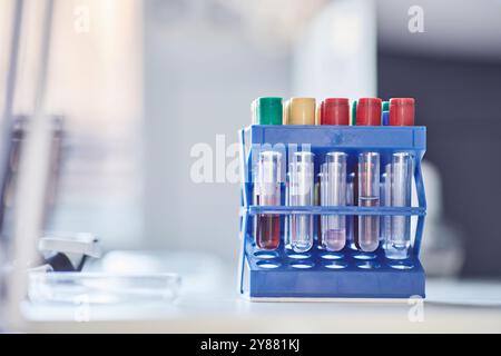 Close up on multiple samples with chemicals on plastic test tube rack resting on scientists workstation in laboratory, copy space Stock Photo