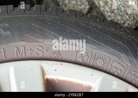 Rubber car tire with different logos. The 3PMSF logo (Three Peak Mountain Snow Flake) is mandatory in some european countries during the winter season Stock Photo