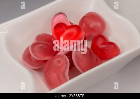 Close-up of red and pink jelly hearts in white dish Stock Photo