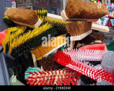 Brooms and brushes on sale at a shop selling general household goods and cleaning products, UK Stock Photo