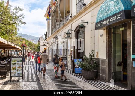 People walk past the majestic Ritz building on Avenue Arriaga in the pleasant center of Funchal. Stock Photo