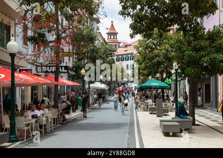 People walking through a busy shopping street in the center of Funchal. Stock Photo