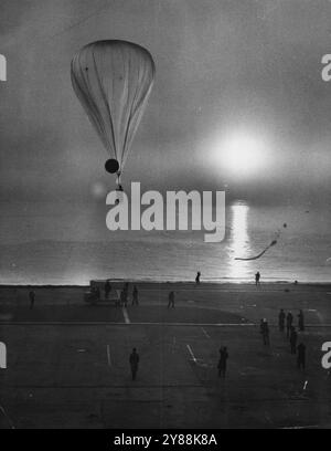 A giant weather balloon being released form a U.S. base. It is equipped with the latest devices, like the robot radio (seen in Photo below, right), which signals meteorological data form tremendous heights. Giant weather balloon being released from an American naval base. It is equipped with the latest meteorological devices to provide weather data at great heights. February 17, 1955. Stock Photo