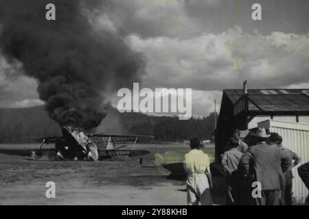 Blazing Plane. At Rotorua (NZ) aerodrome on Sunday, the five occupants of this plane, including a newly-married couple, escaped unhurt when it caught fire. January 18, 1950. Stock Photo