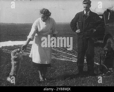 Space dog Limonechev in training. She had just been retrieved by parachute from a rocket flight.Today I made a space flight in Russian rocket. Perched 100 miles above the earth I watched with fascination the reactions of a space dog in flight. Through a transparent dome on the satellite the small white dog appeared content and comfortable. I became a space traveller at a film taken by a 16-millimetre camera mounted on a rocket. With Laika -- The film will be released in all States tomorrow. It explains the launching of Sputnik and the training of the Russian space dogs. At the special preview Stock Photo