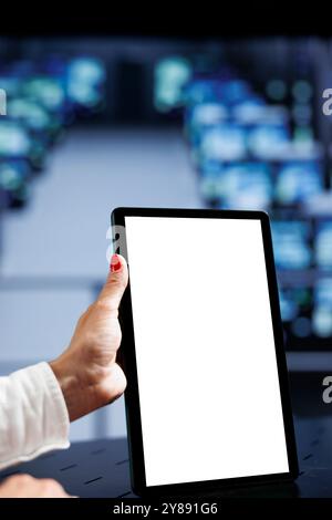 Close up shot of mock up tablet used by certified IT specialist in data center using server clusters to deliver massive computing power, control network resources, process and store datasets Stock Photo