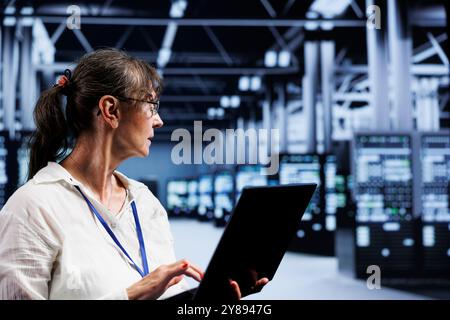 Supervisor overseeing high tech company providing computing resources needed for AI to process extensive datasets for training. Server devices storing datasets used for machine learning Stock Photo