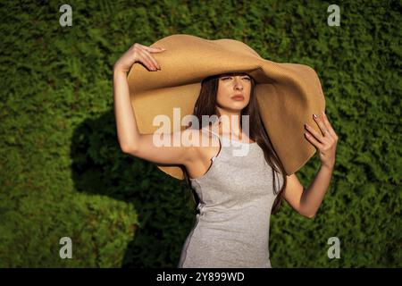 Young beautiful woman with big summer hat Stock Photo