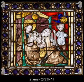 The Adoration of the Magi. A two-part series stained-glass window in Kościół Świętej Trójcy [Holy Trinity Church] in Kraków [Cracow], Poland. Stock Photo