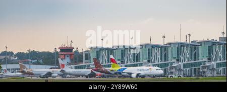 Balikpapan, Indonesia - September 26th, 2024. Airplane towed off apron. ready to depart. a bustling airport scene with several planes parked on the ap Stock Photo