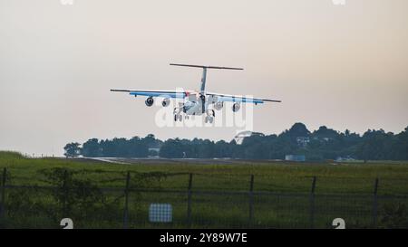 Balikpapan, Indonesia - September 26th, 2024. The plane's landing gear is extended, and the engines are visible as it descends towards a runway. Stock Photo