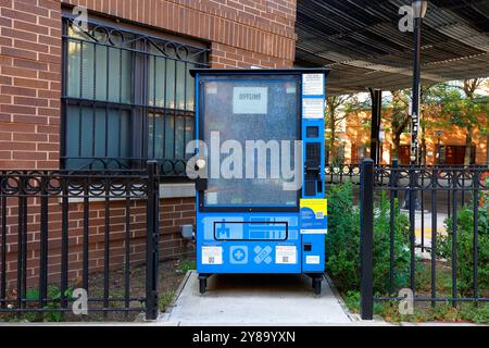 An offline, smashed, vandalized NYC Public Health Vending Machine dispensing opioid overdose rescue kits containing Nalonone, toiletries, and condoms. Stock Photo